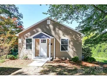 Charming single-story home featuring tan siding, white trim and a cozy covered entrance at 602 Childs St, Lincolnton, NC 28092