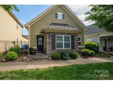 Charming home featuring a combination of stone and shingle siding, complemented by manicured landscaping at 6029 Bountiful St, Belmont, NC 28012