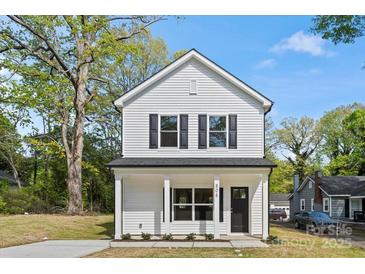 Charming two-story home with white siding, black shutters, and a welcoming front porch at 808 Carolyn Ave, Kannapolis, NC 28083