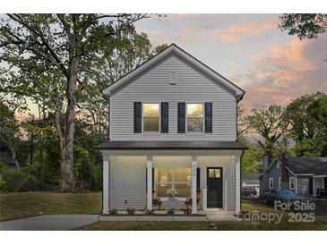 Charming two-story home with gray siding, black shutters, and a welcoming front porch at 808 Carolyn Ave, Kannapolis, NC 28083