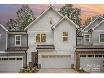 Charming new construction home features a two-car garage, light gray exterior, and well-maintained landscaping at 10528 Audubon Ridge Dr, Cornelius, NC 28031