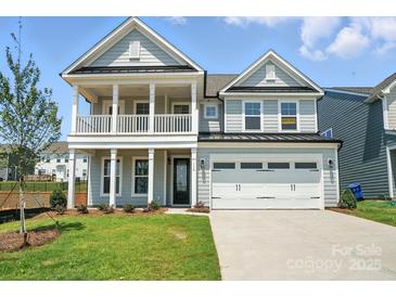 Charming two-story home with a welcoming front porch and attached two-car garage at 119 Longwood Rd # 62, Mooresville, NC 28115