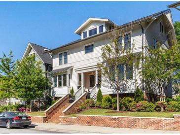 Inviting two-story home featuring a brick-lined staircase, complemented by landscaped greenery and a classic architectural design at 2500 Marshall Pl, Charlotte, NC 28203