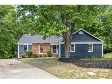 Charming blue home featuring a combination of brick and vinyl siding, complemented by a well-maintained front yard at 2848 Briar Ridge Dr, Charlotte, NC 28270