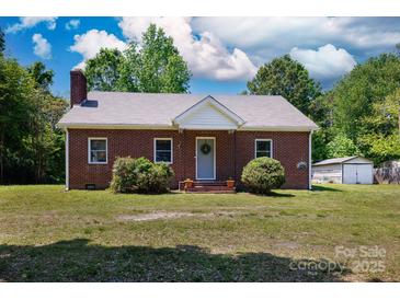 Charming brick home with a well-maintained lawn, traditional design, and inviting curb appeal under a partly cloudy sky at 311 Airport Rd, Rock Hill, SC 29732