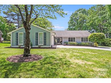 Charming ranch-style home with mature landscaping and a circular driveway on a sunny day at 3619 Chilham Pl, Charlotte, NC 28226
