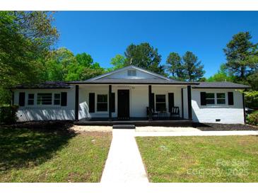 Charming single-story home featuring a covered front porch and a manicured lawn at 502 Hyde St, Kannapolis, NC 28083
