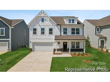 Charming two-story home with white siding, a welcoming front porch, and well-manicured lawn at 510 Black Bear St # 145P, China Grove, NC 28023