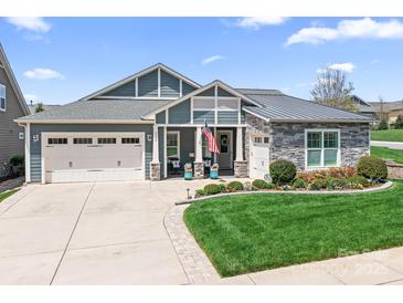 Inviting home featuring a well-manicured lawn, a two-car garage, and stone and siding details at 5103 Looking Glass Trl, Denver, NC 28037