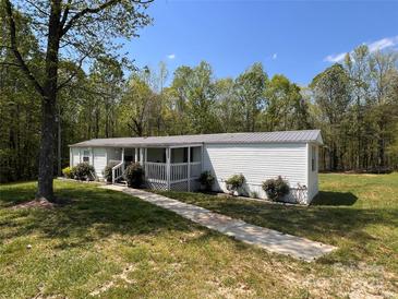 Charming single-story home with a cozy front porch and a well-maintained yard at 143 Ezra Rd, Kings Mountain, NC 28086
