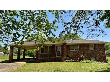 Charming brick home featuring a covered parking area and well-maintained front lawn at 1684 Montevista Dr, Shelby, NC 28150