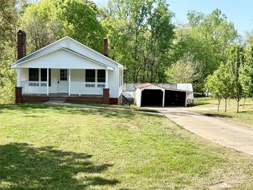 Charming white home with a cozy front porch and well-maintained lawn at 2724 Peachtree Rd, Statesville, NC 28625