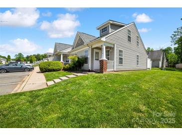 View of the exterior of a well-manicured townhome with a green lawn and sidewalk at 3219 Cottage Rose Ln, Rock Hill, SC 29732