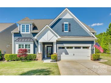 Charming two-story home with a well-manicured lawn, attached garage, and beautiful blue siding at 4083 Home Grown Way, Clover, SC 29710