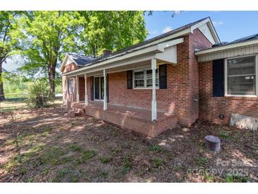 Charming brick home featuring a covered front porch with white columns and ample space at 4734 Polk Ford Rd, Stanfield, NC 28163
