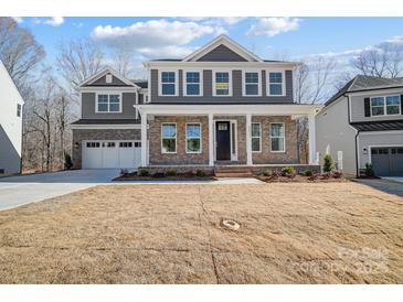 Beautiful two-story home with a two car garage and manicured front lawn at 5027 Mclaughlin Loop # 61, Waxhaw, NC 28173