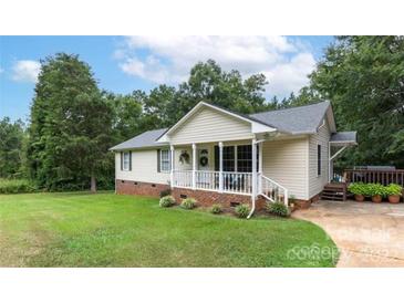 Charming single-story home with a welcoming front porch, well-maintained lawn, and mature trees at 592 Rambo E Rd, Rock Hill, SC 29730