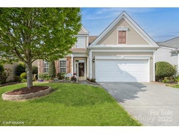 Charming home with a well-manicured lawn, two-car garage, and tasteful landscaping at 10314 Threatt Woods Dr, Charlotte, NC 28277