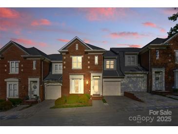 Charming brick townhouse with a well-maintained front yard and attached garage at 1139 Hampton Gardens Ln, Charlotte, NC 28209