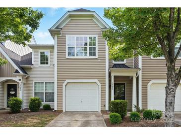 Charming townhouse exterior with a one-car garage, inviting front door, and well-maintained landscaping at 14649 Lions Paw St, Charlotte, NC 28273