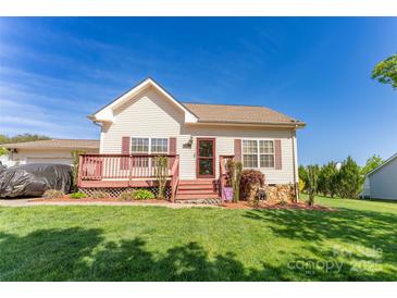 Charming single-story home with a cozy front porch and well-maintained lawn, perfect for relaxing outdoors at 1556 Berkshire Dr, Newton, NC 28658