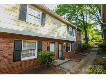 Traditional brick townhouse with black shutters, and landscaped entrance at 2332 Kenmore Ave, Charlotte, NC 28204