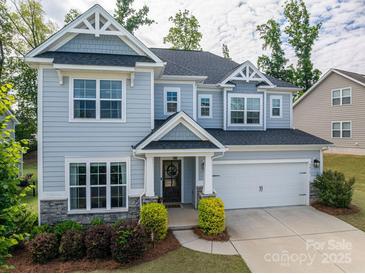 Charming two-story home with a well-manicured lawn and welcoming front porch at 3017 Winged Teal Ct, Belmont, NC 28012