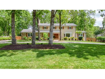 Charming two-story home with mature trees, stone accents, shutters, and a manicured lawn at 323 Richmond Rd, Salisbury, NC 28144