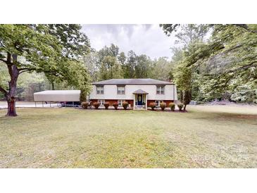 Charming split-level home with manicured lawn and convenient covered parking at 3816 Redman Rd, Shelby, NC 28150