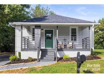 Charming home featuring a covered front porch and a beautifully landscaped yard at 403 Broad St, Kannapolis, NC 28081