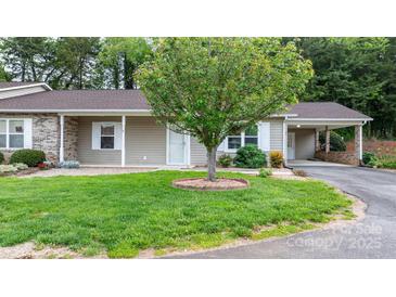 Charming home featuring a lush lawn, complemented by a decorative tree and a convenient carport at 505 2Nd Street Ne Pl # C4, Conover, NC 28613