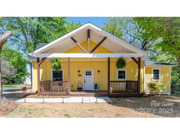 Inviting yellow home featuring a charming porch and crisp white trim details at 530 W Franklin St, Salisbury, NC 28144