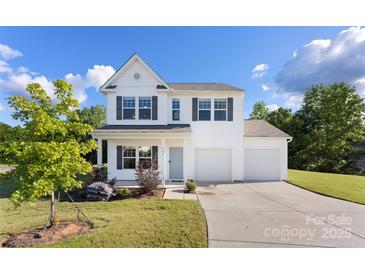 Charming two-story home with a welcoming front porch and a spacious two car garage at 548 Dutch White Dr, Clover, SC 29710