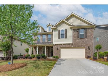 Charming two-story brick home with a well-manicured lawn and attached two-car garage, offering curb appeal at 866 Tyne Dr, Fort Mill, SC 29715