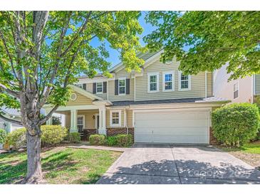 Charming two-story home with a two-car garage, lush landscaping, and a welcoming front porch at 8919 Oransay Way, Charlotte, NC 28278