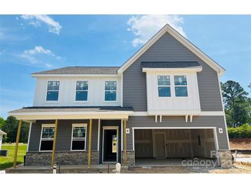 New two-story home featuring gray siding and a two-car garage at 1004 Rocking Horse Rd, Indian Trail, NC 28079