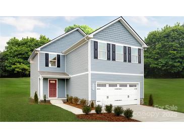 Charming two-story home with blue siding, attached garage and a well-manicured lawn at 120 Millstream Dr, China Grove, NC 28023