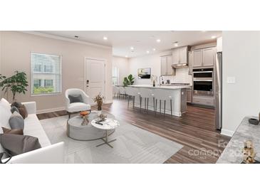 Bright open-concept living room flows into the kitchen with an island and stainless steel appliances at 13210 Kenworth Rd, Charlotte, NC 28278