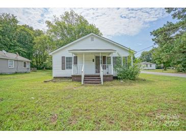Charming single-story home with white siding, a covered porch, and well-maintained landscaping at 1343 Flint Hill St, Rock Hill, SC 29730