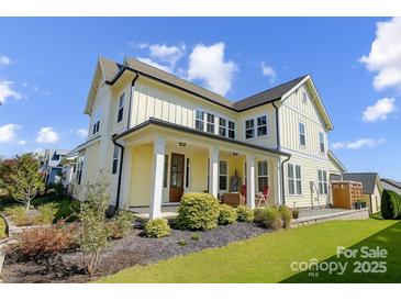 Charming two-story home boasts a welcoming front porch and beautifully landscaped front yard at 1507 Riverwalk Pkwy, Rock Hill, SC 29730