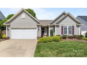 Charming single-Gathering home featuring a two-car garage and well-maintained front yard and landscaping at 2006 Holly Villa Cir, Indian Trail, NC 28079