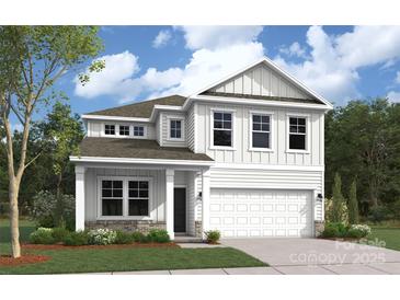 Beautiful two-story home with white siding, a two-car garage, and a well-manicured lawn at 2019 Puddle Pond Rd, Indian Trail, NC 28079