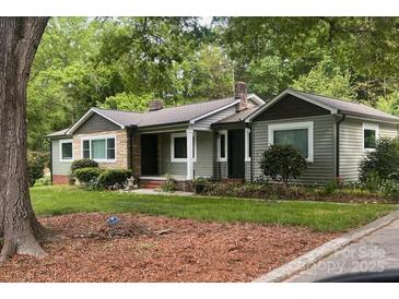 Charming home with a mix of materials, green lawn, mature trees, and traditional architecture at 20337 Nc Hwy 73 Hwy, Albemarle, NC 28001