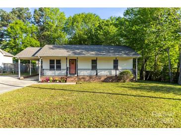 Charming single-story home with covered porch, front yard, and carport, offering a cozy curb appeal at 304 W Fourth St, Cherryville, NC 28021