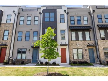 Modern townhome exteriors showcase brick and siding, with colorful doors and lush landscaping at 3223 Beans Blvd, Charlotte, NC 28203