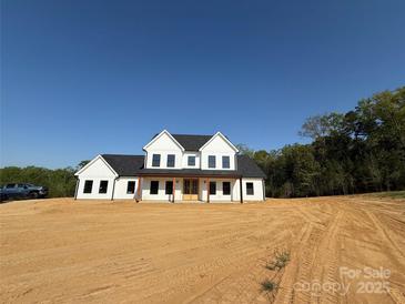 New two-story home with white siding and a dark roof, set against a blue sky at 4034 Daugherty Rd, China Grove, NC 28023