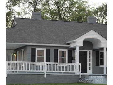 Charming single-story home with a cozy front porch and gray painted brick exterior at 406 S Catawba St, Lancaster, SC 29720