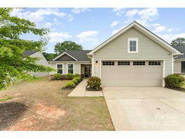 Charming single-Gathering home with light siding, a two-car garage, and manicured landscaping at 4219 Mackinnon Dr, Charlotte, NC 28214
