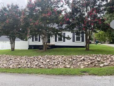 Charming single-story home with white siding, black shutters, and blooming crape myrtle trees at 507 Chrysler St, Kannapolis, NC 28083