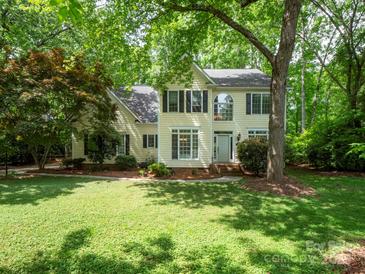 Charming two-story home with traditional architecture and lush front lawn surrounded by mature trees at 6100 Hunter Ln, Weddington, NC 28104